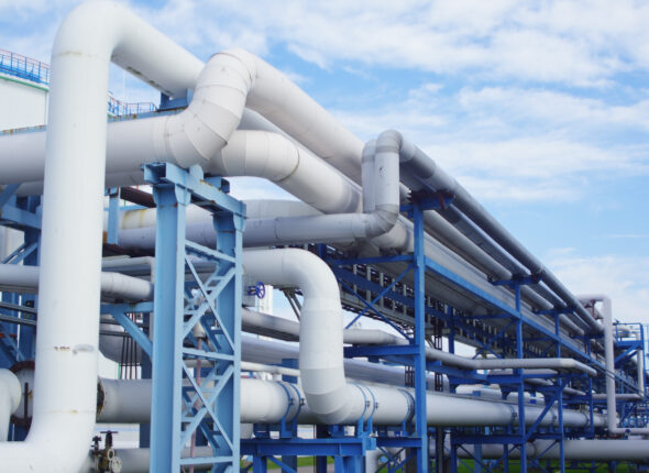 Closeup of industrial pipelines around a factor on a sunny day